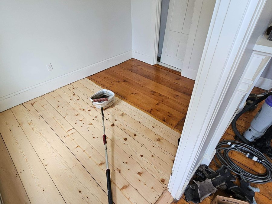 Hemlock floor half sanded to bare wood and half finished